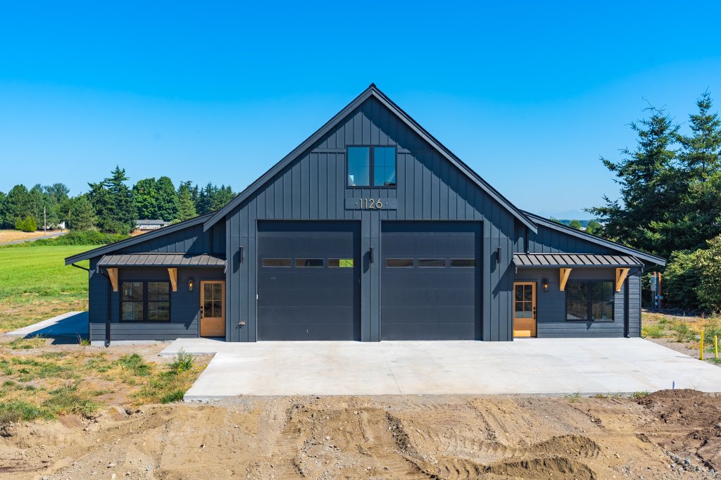 Modern board-and-batten barn-style garage on a fresh concrete pad