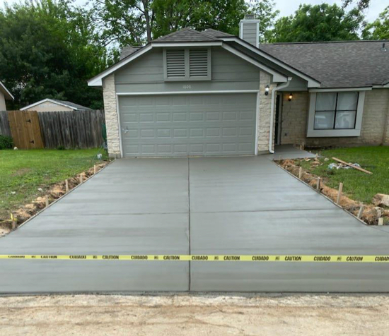 Freshly poured residential concrete driveway with broom finish